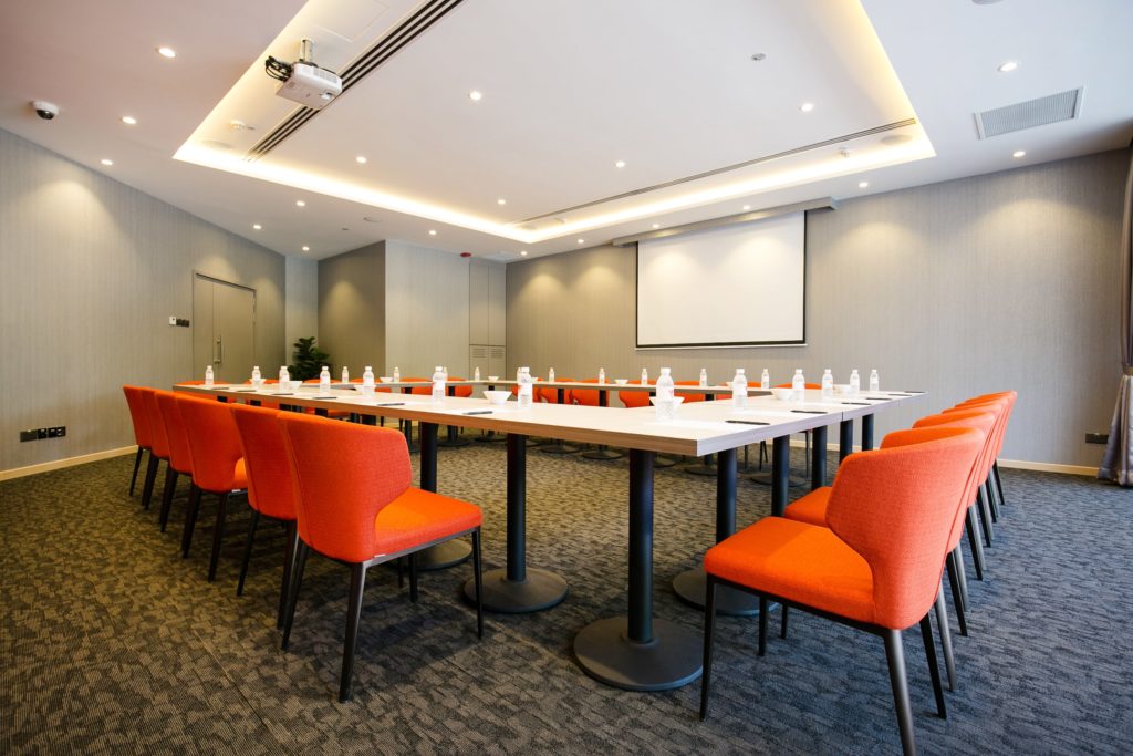 metropolitan ymca singapore room with orange chairs